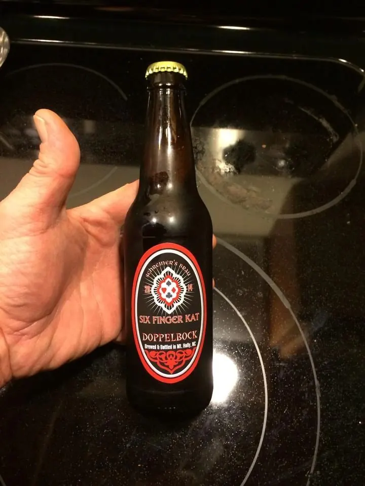 A hand holding a bottle of Six Finger Kat Doppelbock